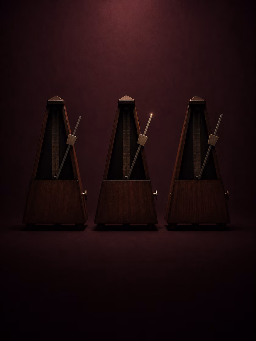 Three metronomes in a row, perfectly in sync